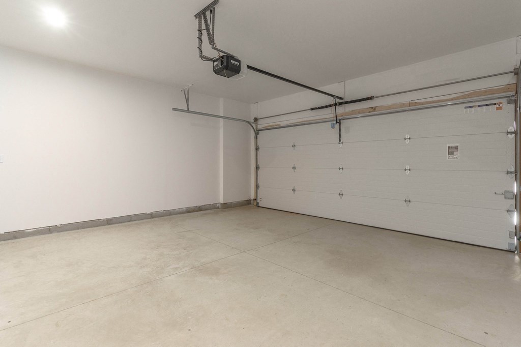 the interior of a garage with a white wall and a garage door